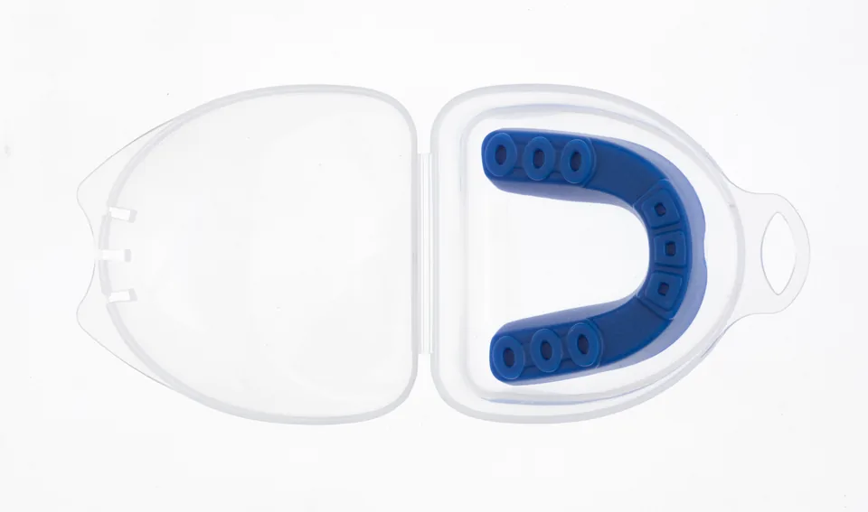 A sports mouth guard and its case
