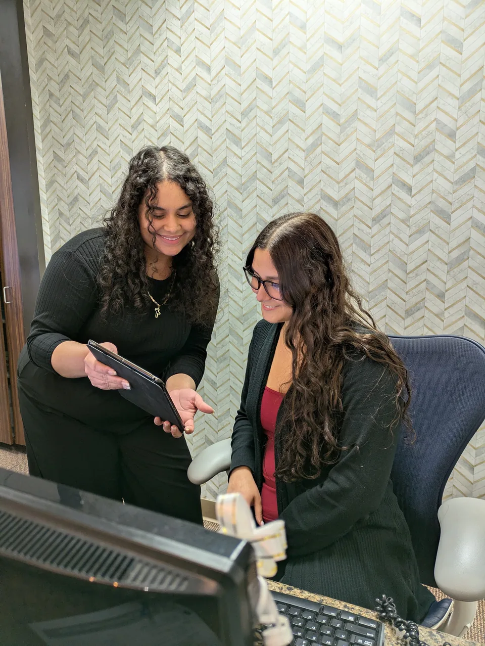 The receptionist and a patient at the front desk