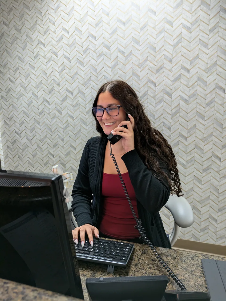 The receptionist on the phone at the front desk